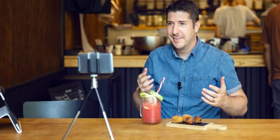A micro-influencer at a restaurant, talking to their followers, showcasing their affiliate marketing value